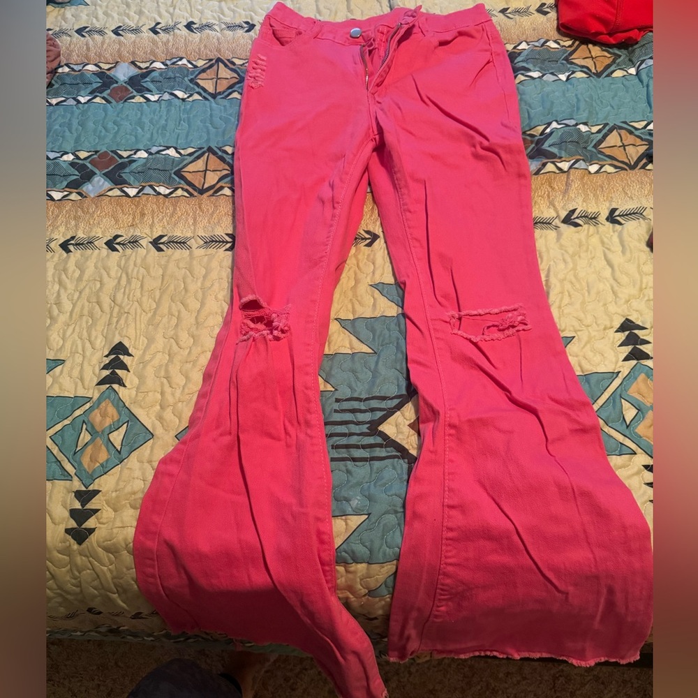 Pink distressed bell bottoms